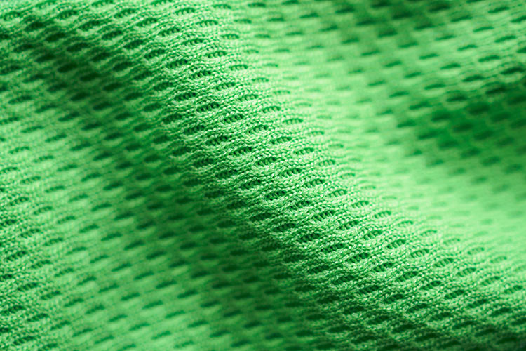 Upclose image of green sporstwear fabric